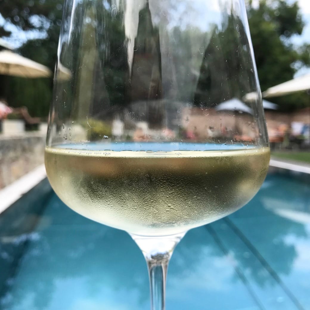 White wine by the pool Image of wine glass